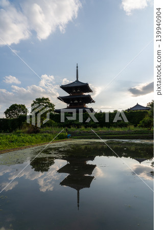 A photograph of the warming rice paddies reflecting Hokiji Temple, a scene from early summer in Ikaruga. A photograph of the warming rice paddies reflecting Hokiji Temple, a scene from early summer in Ikaruga. 139940904