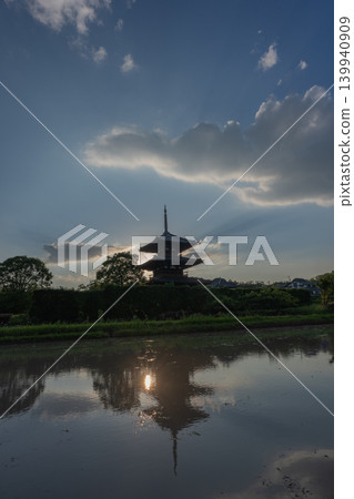 A photograph of the warming rice paddies reflecting Hokiji Temple, a scene from early summer in Ikaruga. A photograph of the warming rice paddies reflecting Hokiji Temple, a scene from early summer in Ikaruga. 139940909