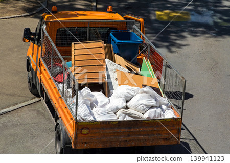 Collecting bulk garbage in tipper truck 139941123
