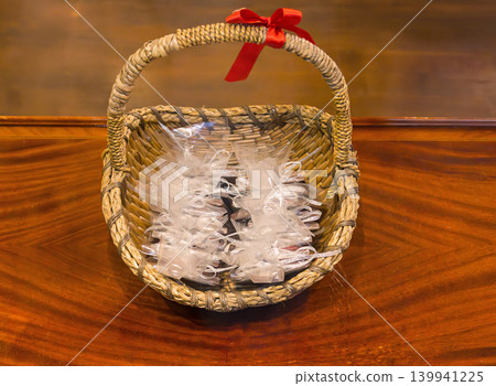 Rattan basket with decorative pouches ribbons 139941225