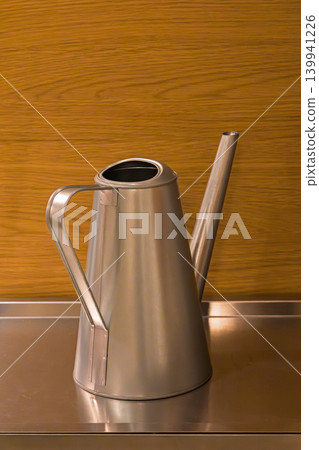 Retro metal decanter on shelf 139941226