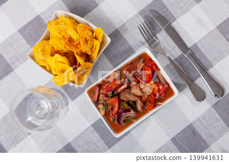 Ceviche served with fried banana in bowl 139941631