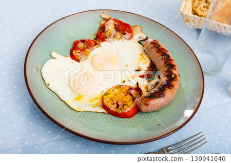 Healthy breakfast of scrambled eggs with sausages Healthy breakfast of scrambled eggs with sausages 139941640