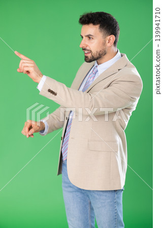 Adult man presses buttons on virtual screen and expresses various emotions. Chroma key compositing. Adult man presses buttons on virtual screen and expresses various emotions. Chroma key compositing. 139941710