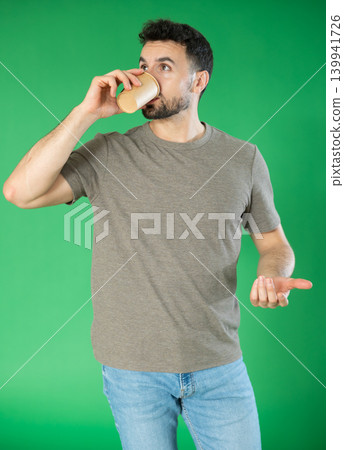 Young man and coffee break on green screen background 139941726