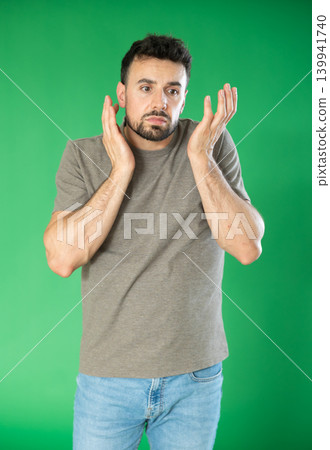 Adult man sad and upset in front of green screen Adult man sad and upset in front of green screen 139941740