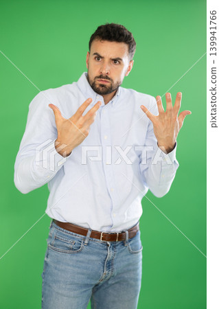 Adult man confused and forgetful in front of green screen Adult man confused and forgetful in front of green screen 139941766