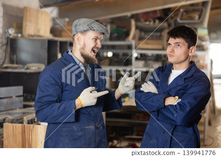 Quarrel between two workers at furniture factory - foreman yells at offending worker Quarrel between two workers at furniture factory - foreman yells at offending worker 139941776