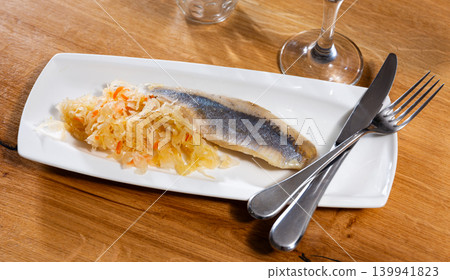 Sliced herring served with sauerkraut Sliced herring served with sauerkraut 139941823
