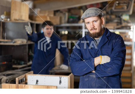 Young male carpenters quarreling in workshop Young male carpenters quarreling in workshop 139941828