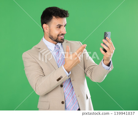 Adult man taking selfie in front of green screen Adult man taking selfie in front of green screen 139941837
