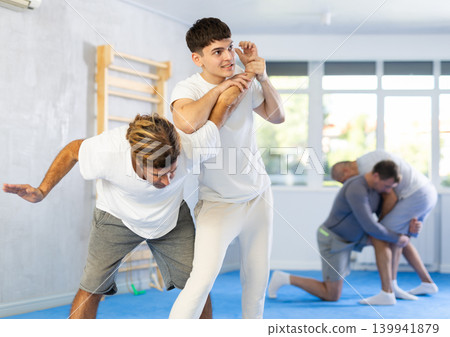 Self defense training for adults - men learn how to do power grabs Self defense training for adults - men learn how to do power grabs 139941879