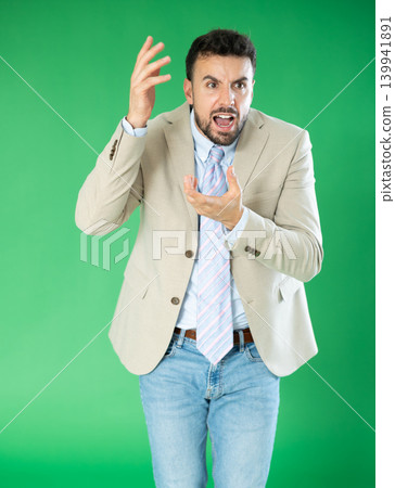 Outraged European young man is yelling at someone. Outraged European young man is yelling at someone. 139941891