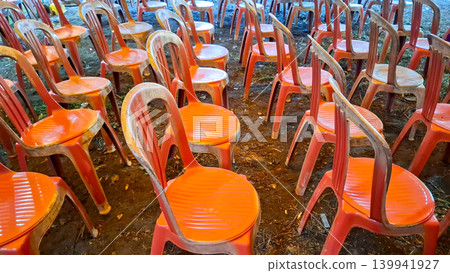 Row of Orange Plastic Chairs in Outdoor Event Area Row of Orange Plastic Chairs in Outdoor Event Area 139941927