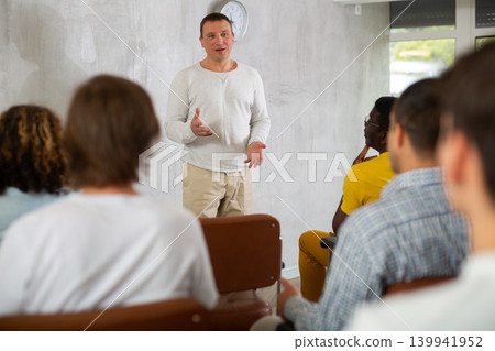 Middle-aged man teacher reading lecture for a group of guys 139941952