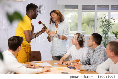 African american man gives a flower to his male partner 139941991