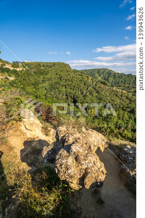 Majestic rocky cliffs and towering pine trees against blue sky. Majestic rocky cliffs and towering pine trees against blue sky. 139943626