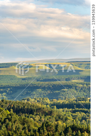Layers of green mountains and hills in the haze during sunset. Panoramic View of Green hills and Meadow. Layers of green mountains and hills in the haze during sunset. Panoramic View of Green hills and Meadow. 139943639