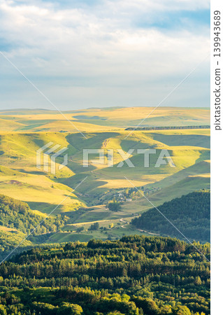 Layers of green mountains and hills in the haze during sunset. Panoramic View of Green hills and Meadow. Layers of green mountains and hills in the haze during sunset. Panoramic View of Green hills and Meadow. 139943689
