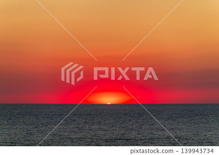 Beautiful red and orange sunrise over the sea. Beautiful red and orange sunrise over the sea. 139943734