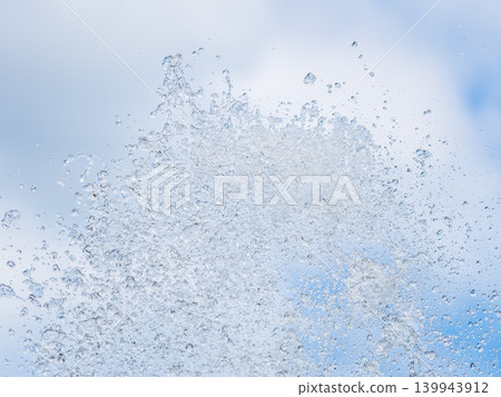 Splashes and jets of water against light background. Splashes and jets of water against light background. 139943912