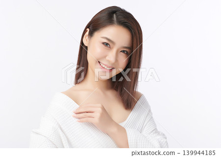 A beautiful young Asian woman with clean, fresh skin against a white background. Skincare, facial treatment, cosmetology, beauty, and spa. An elegant portrait of an Asian woman. 139944185
