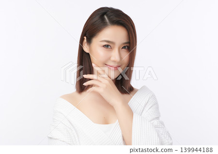 A beautiful young Asian woman with clean, fresh skin against a white background. Skincare, facial treatment, cosmetology, beauty, and spa. An elegant portrait of an Asian woman. A beautiful young Asian woman with clean, fresh skin against a white background. Skincare, facial treatment, cosmetology, beauty, and spa. An elegant portrait of an Asian woman. 139944188
