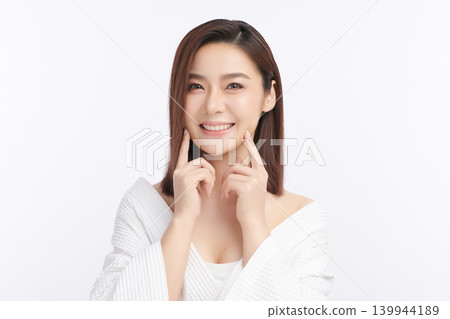 A beautiful young Asian woman with clean, fresh skin against a white background. Skincare, facial treatment, cosmetology, beauty, and spa. An elegant portrait of an Asian woman. A beautiful young Asian woman with clean, fresh skin against a white background. Skincare, facial treatment, cosmetology, beauty, and spa. An elegant portrait of an Asian woman. 139944189