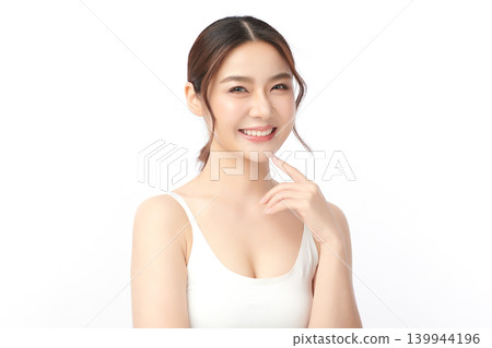 A beautiful young Asian woman with clean, fresh skin against a white background. Skincare, facial treatment, cosmetology, beauty, and spa. An elegant portrait of an Asian woman. A beautiful young Asian woman with clean, fresh skin against a white background. Skincare, facial treatment, cosmetology, beauty, and spa. An elegant portrait of an Asian woman. 139944196
