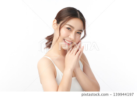 A beautiful young Asian woman with clean, fresh skin against a white background. Skincare, facial treatment, cosmetology, beauty, and spa. An elegant portrait of an Asian woman. 139944197
