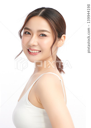 A beautiful young Asian woman with clean, fresh skin against a white background. Skincare, facial treatment, cosmetology, beauty, and spa. An elegant portrait of an Asian woman. 139944198