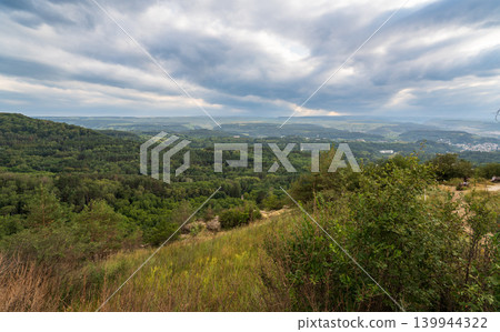 Layers of green mountains and hills in the haze during sunset. Panoramic View of Green hills and Meadow. Layers of green mountains and hills in the haze during sunset. Panoramic View of Green hills and Meadow. 139944322