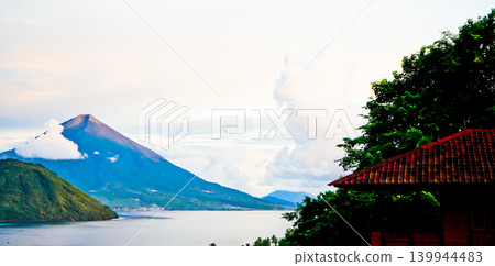 Beautiful view of Maitara Island and Tidore Island in the morning in summer, Ternate, Indonesia Beautiful view of Maitara Island and Tidore Island in the morning in summer, Ternate, Indonesia 139944483