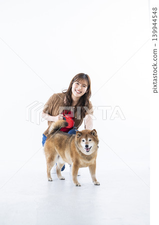 A Shiba Inu and a young woman against a white background. 139944548