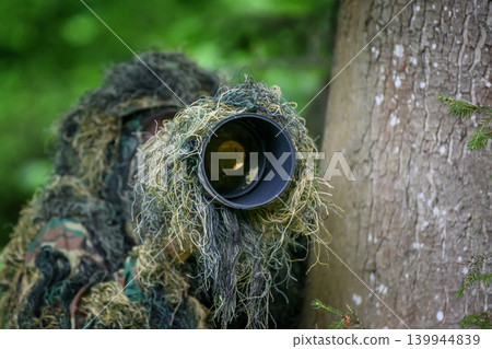 Wildlife photographer in the summer ghillie camouflage suit 139944839