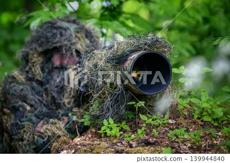 Wildlife photographer in the summer ghillie camouflage suit 139944840
