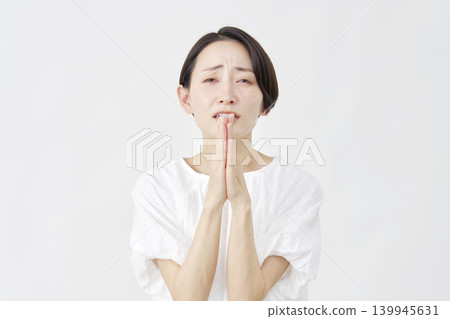 Middle-aged woman pleading, white background Middle-aged woman pleading, white background 139945631