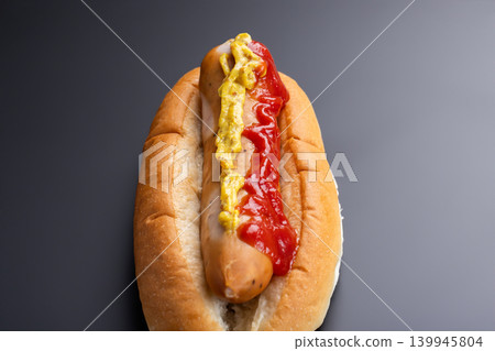 A hot dog with plenty of ketchup and mustard 139945804