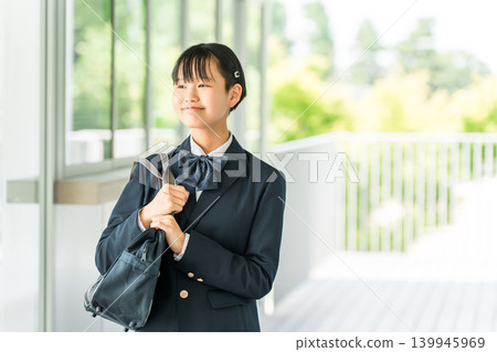 Junior high and high school girls in uniform walking in a school hallway Junior high and high school girls in uniform walking in a school hallway 139945969