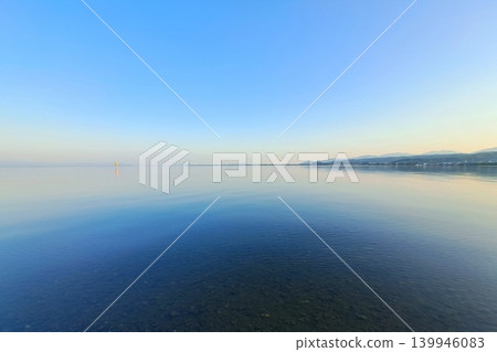 A still, mirror-like surface of water A still, mirror-like surface of water 139946083