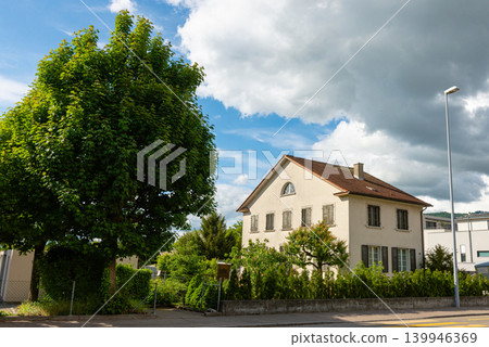 Suburban house street view with green tree photo Suburban house street view with green tree photo 139946369