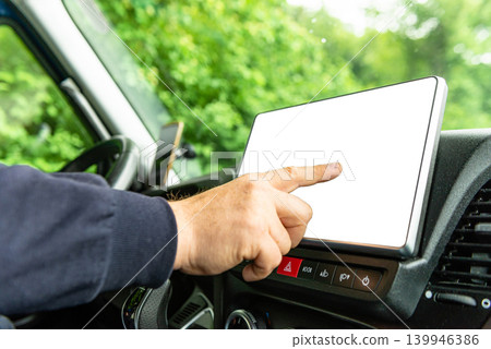 Man using blank touch screen on car console Man using blank touch screen on car console 139946386
