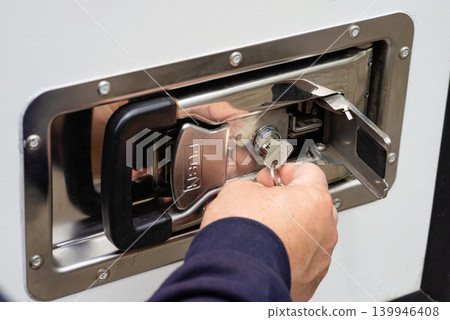 Key inserting into metal storage box lock photo Key inserting into metal storage box lock photo 139946408