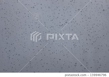 Water drops on glass surface during a rainy day Water drops on glass surface during a rainy day 139946796