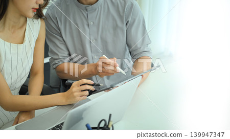 Close up of professionals comparing printed charts and digital data on digital tablet Close up of professionals comparing printed charts and digital data on digital tablet 139947347