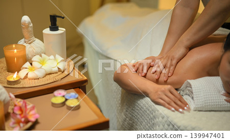 Calm young woman receiving a relaxing shoulder massage at a luxury spa Calm young woman receiving a relaxing shoulder massage at a luxury spa 139947401