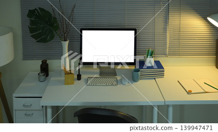 Desktop computer mockup on office desk with lamp and night lighting 139947471