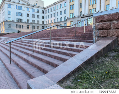 Massive Red Granite Steps with Stainless Steel Handrails in Front of Building Massive Red Granite Steps with Stainless Steel Handrails in Front of Building 139947888