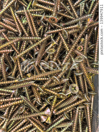 Close up of zinc plated Phillips head wood screws in bulk pile Close up of zinc plated Phillips head wood screws in bulk pile 139947911