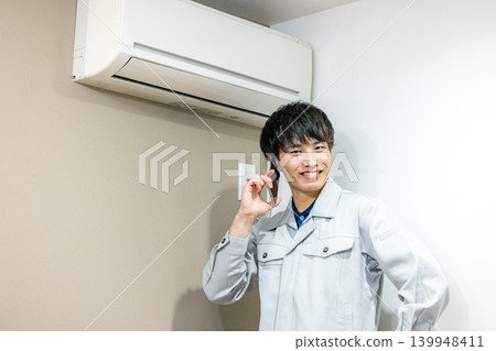 Workers inspecting air conditioners Workers inspecting air conditioners 139948411